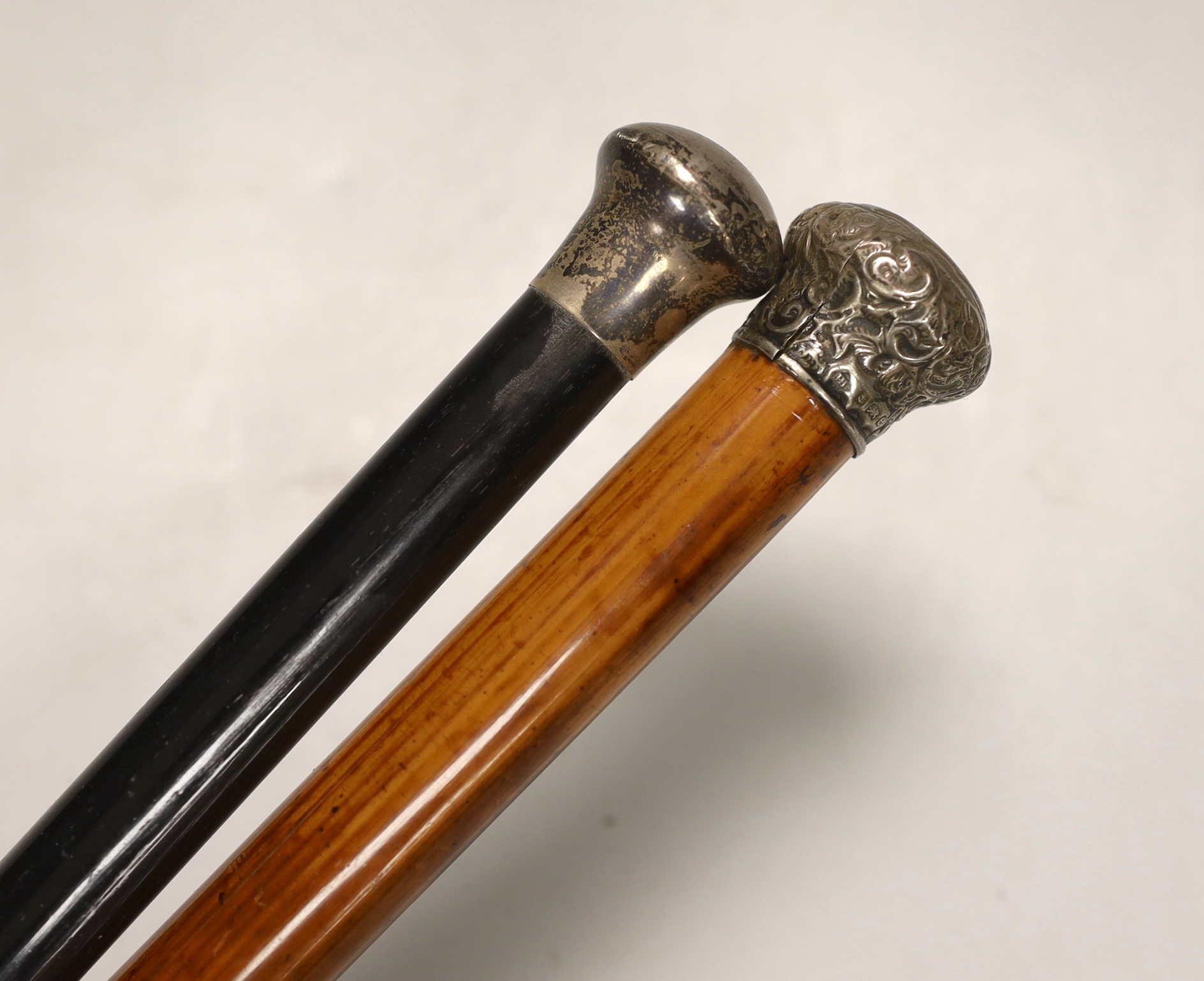 Two Victorian silver mounted canes, longest 93cm